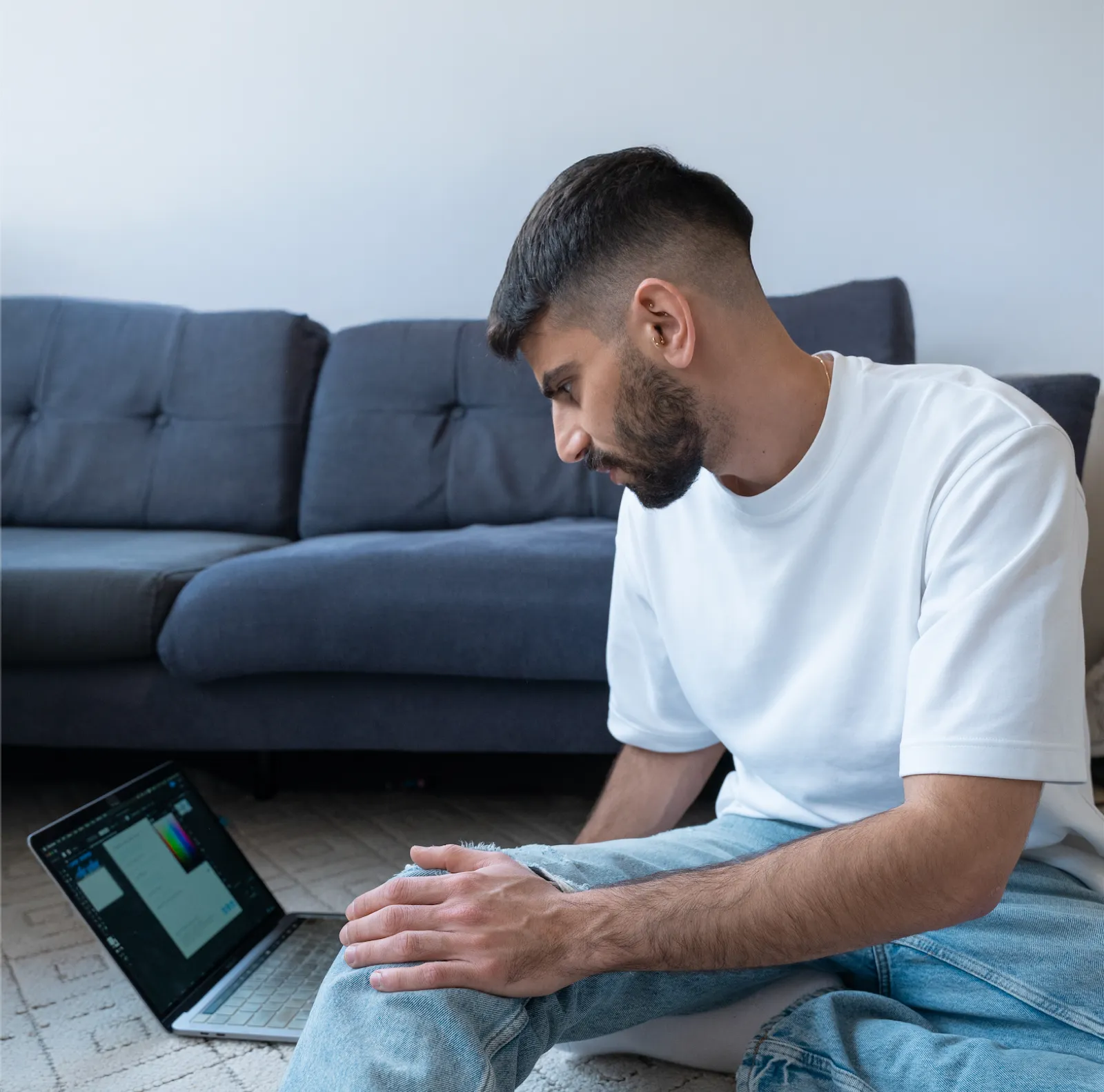 Ofir Sofer working on a brand design on his laptop